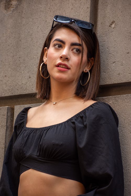 Young Woman in Cropped Black Blouse with Long Sleeves