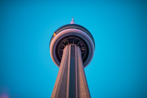 Free A striking view of CN Tower in Toronto, showcasing modern architecture against a bright blue sky. Stock Photo