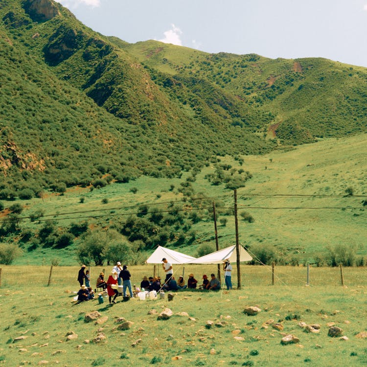 Group Of People Camping In A Valley 