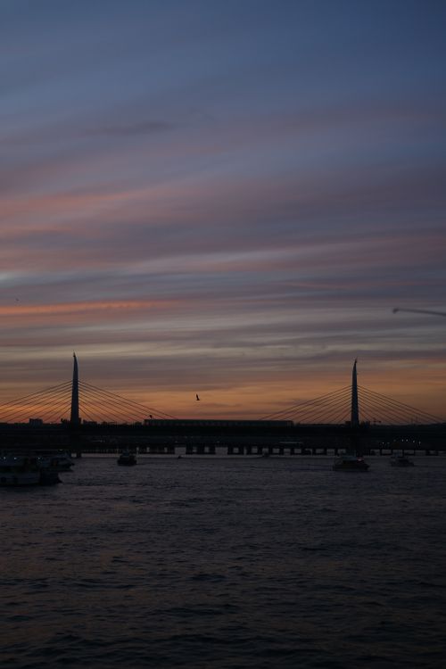 Free Gorgeous silhouette of iconic İstanbul bridge against twilight sky with colorful clouds. Stock Photo