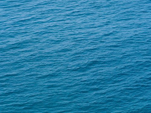 Free Tranquil ocean water with gentle waves, perfect for a serene backdrop. Stock Photo