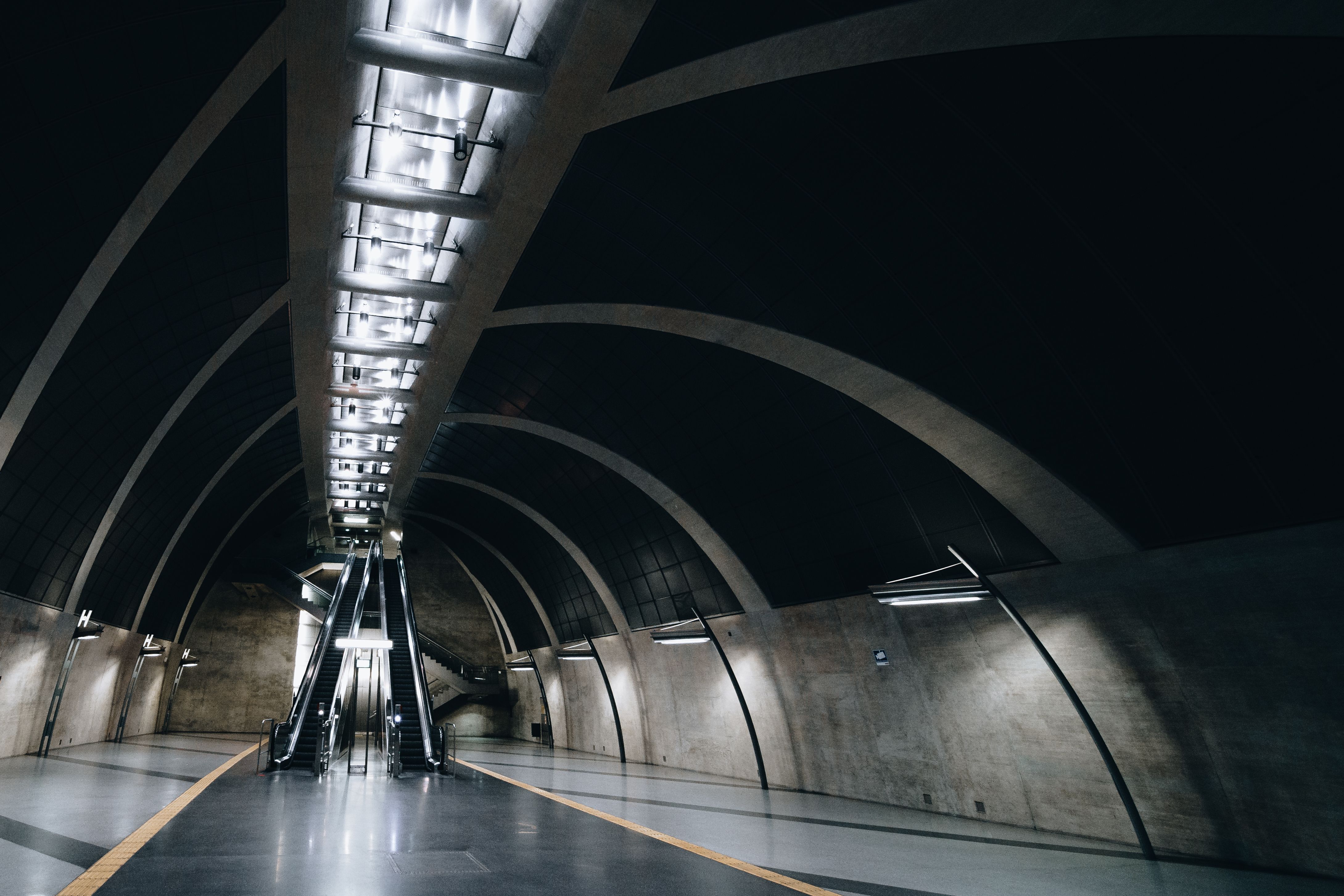 Modern interior of a Doha Metro station in Qatar with people waiting for a train