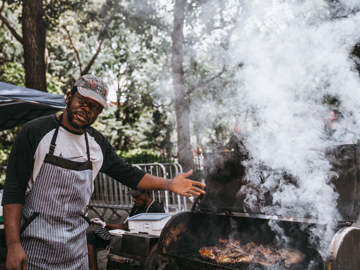 how long to smoke a whole chicken at 225 — outdoor smoker with pale smoke rising during a low-and-slow BBQ cook