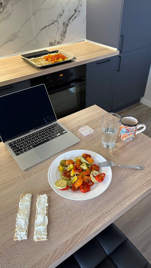 Free Laptop and Meal on Table Stock Photo