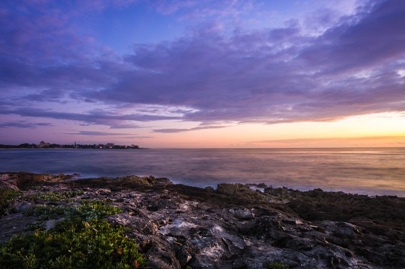 Sunset over the rocky coastline of Akumal, Mexico