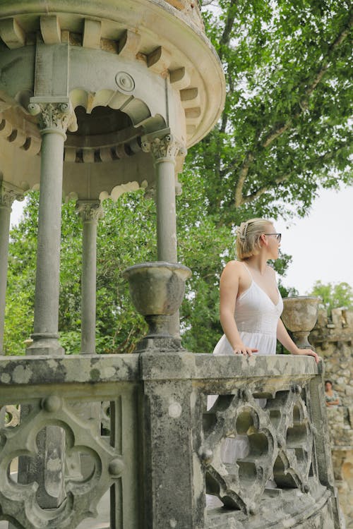 Woman in a White Dress Standing in the Fairytale Tower in Quinta Da Regaleira in Sintra, Portugal