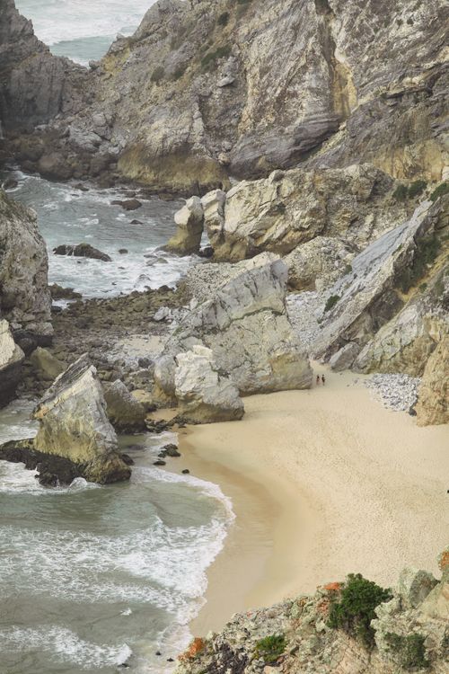 Free Explore the rugged cliffs and serene beach of Praia da Ursa in Portugal's wild coastline. Stock Photo