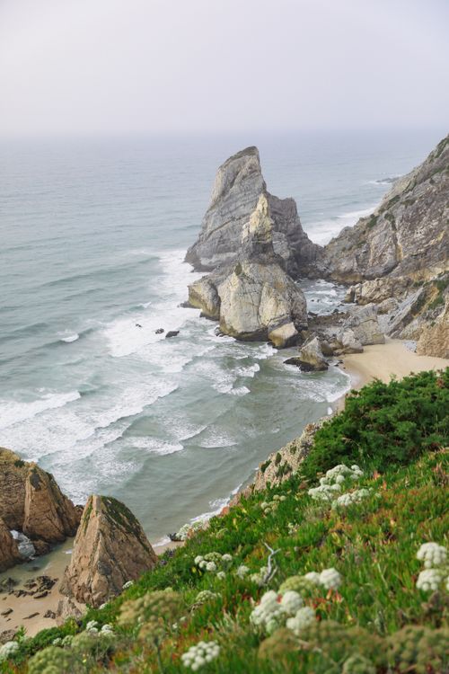 Free High angle view of stunning rock formations and coastline with lush green foreground. Stock Photo