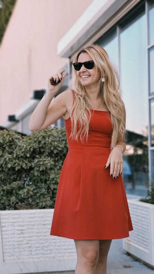 Smiling Blonde Woman in Red Dress