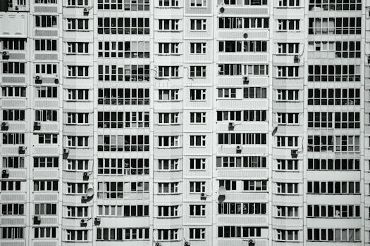 Symmetrical facade of a modern residential building, highlighting urban architecture.