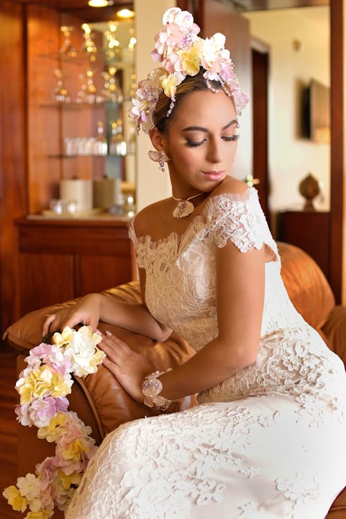 Bride with Bouquets of Flowers Sitting on an Armchair 
