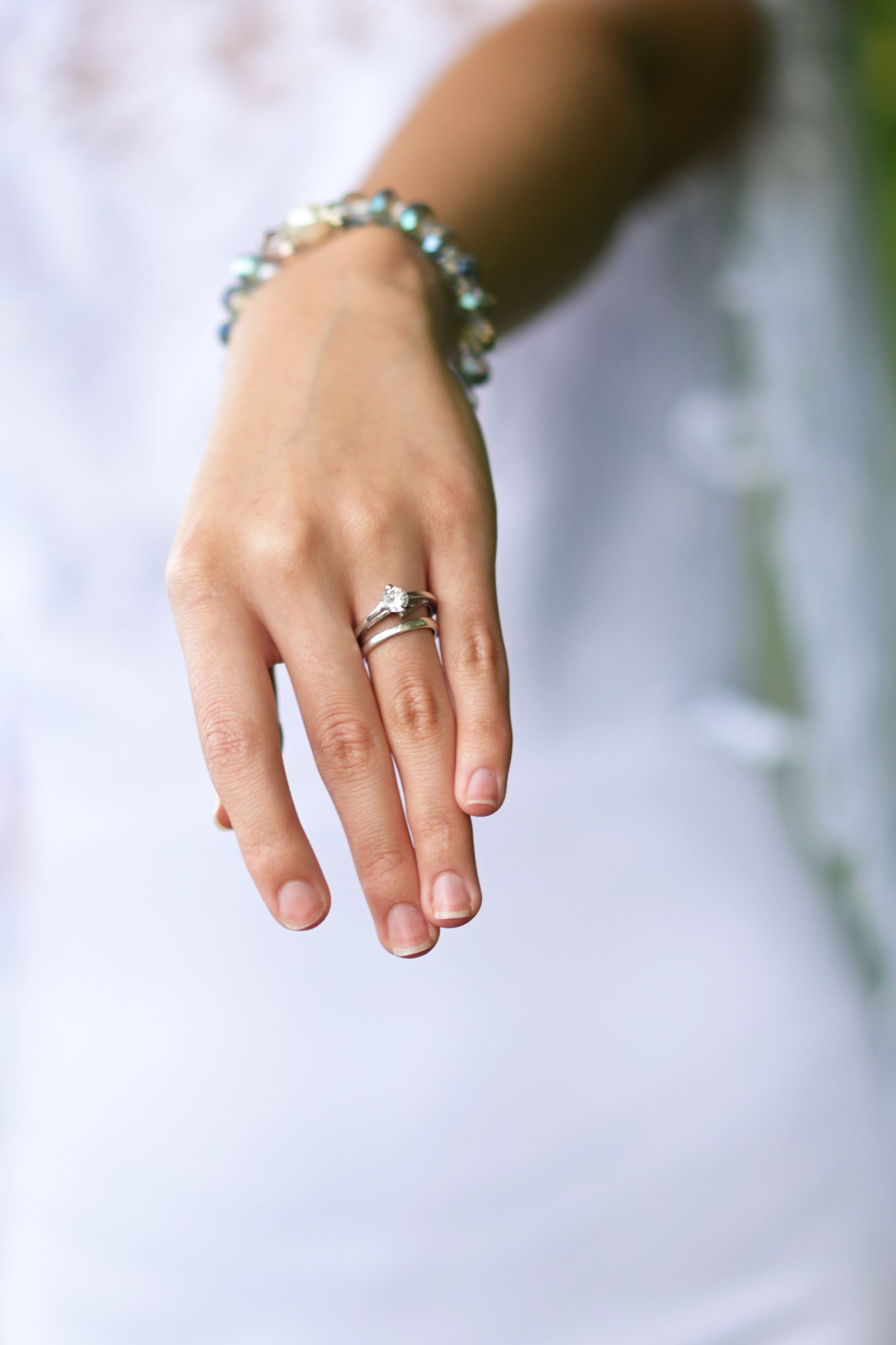 Close-up of a bride's hand with wedding rings and bracelet
