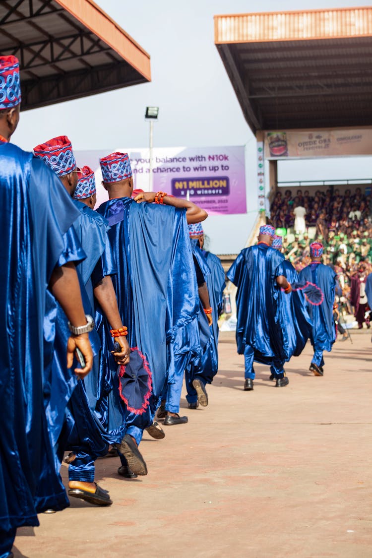 Students In Graduation Gowns Standing In A Line 