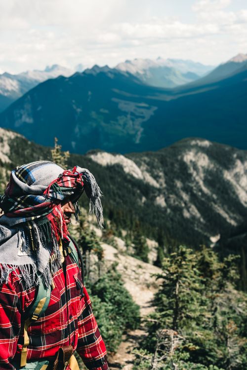 Free Adult male hiker standing in Banff National Park, overlooking mountains and forests. Stock Photo