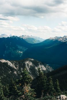 Stunning aerial view of Banff's mountain landscape with dense forests and vast valleys.