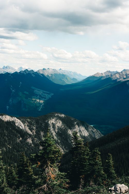 Free Stunning aerial view of Banff's mountain landscape with dense forests and vast valleys. Stock Photo
