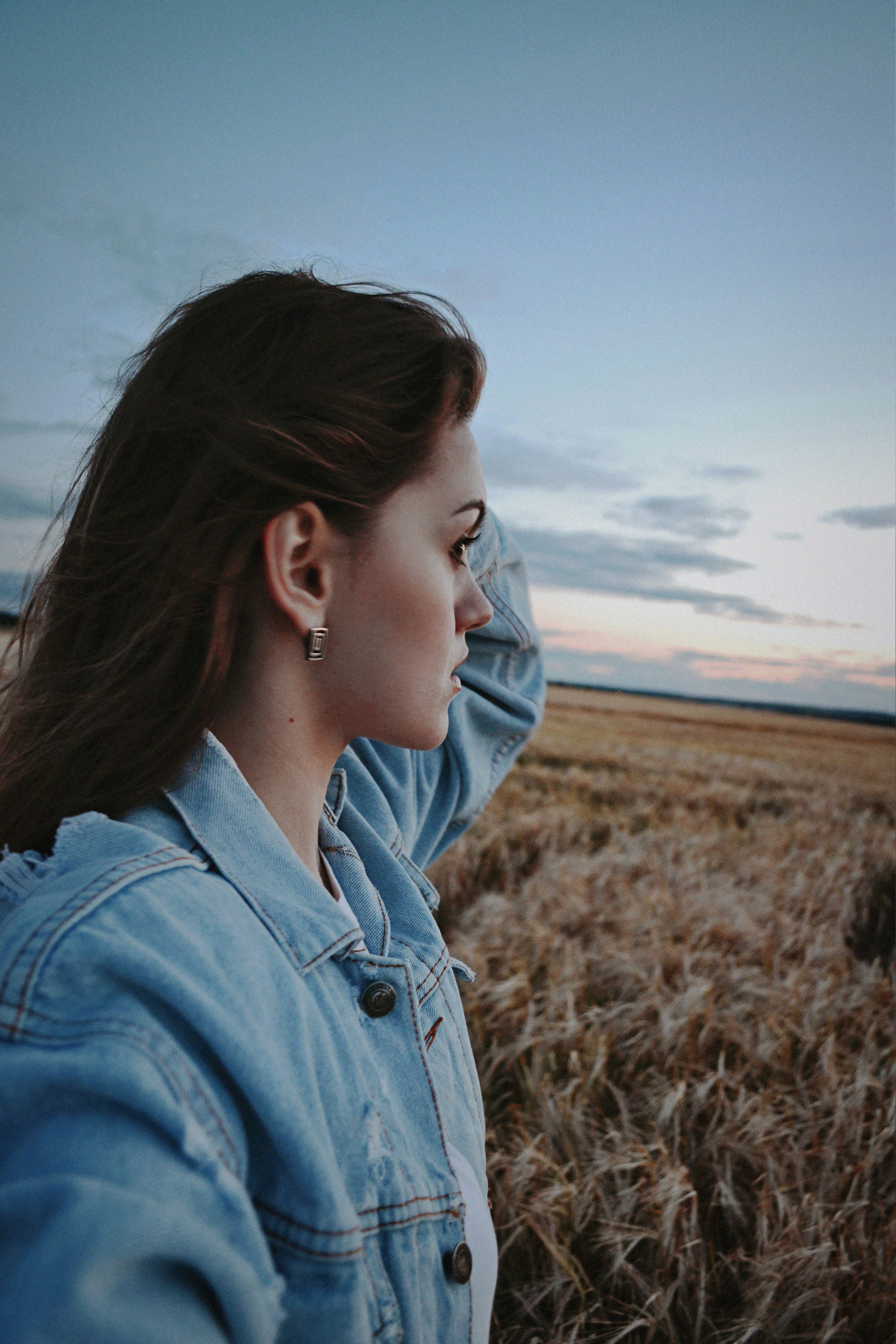 Woman in Denim Jacket Standing on Field · Free Stock Photo