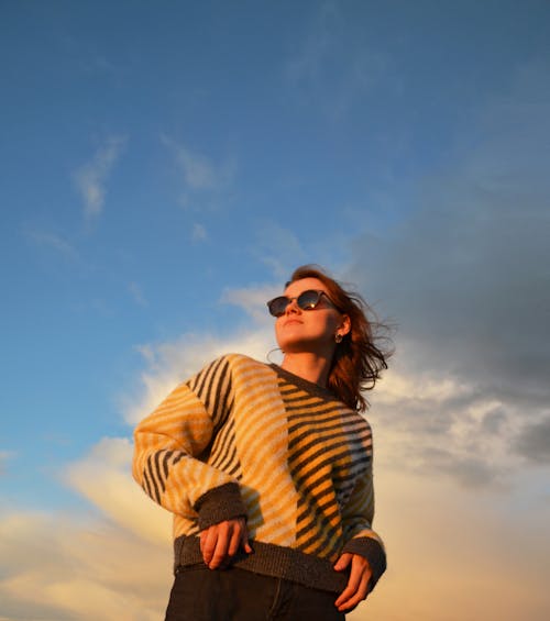 Young Brunette Woman in Sweater at Sunset