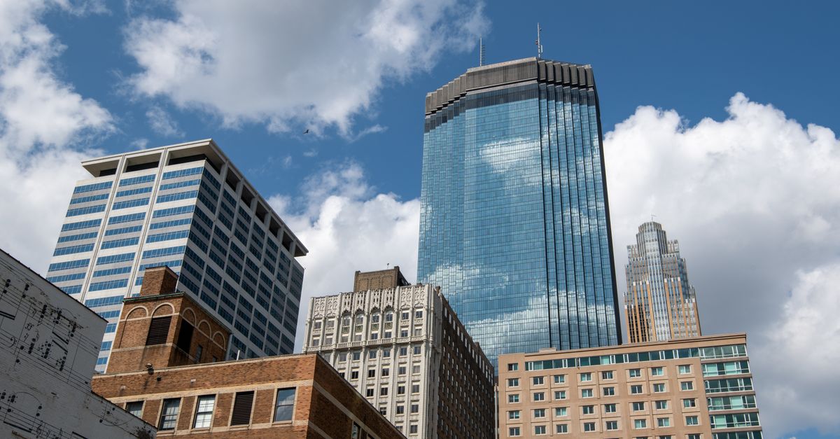 Vibrant cityscape of Minneapolis showcasing tall skyscrapers against a blue sky.