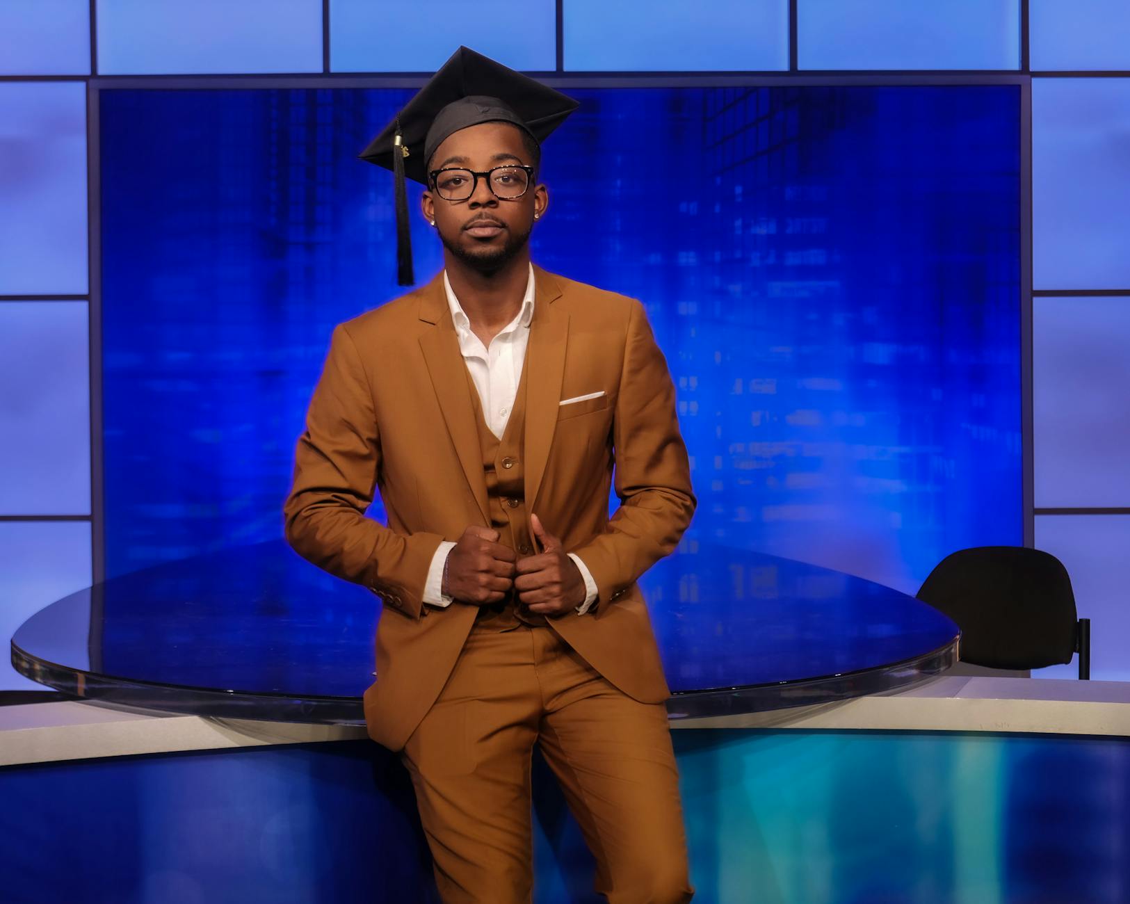 Graduate Student Posing against a Blue Background