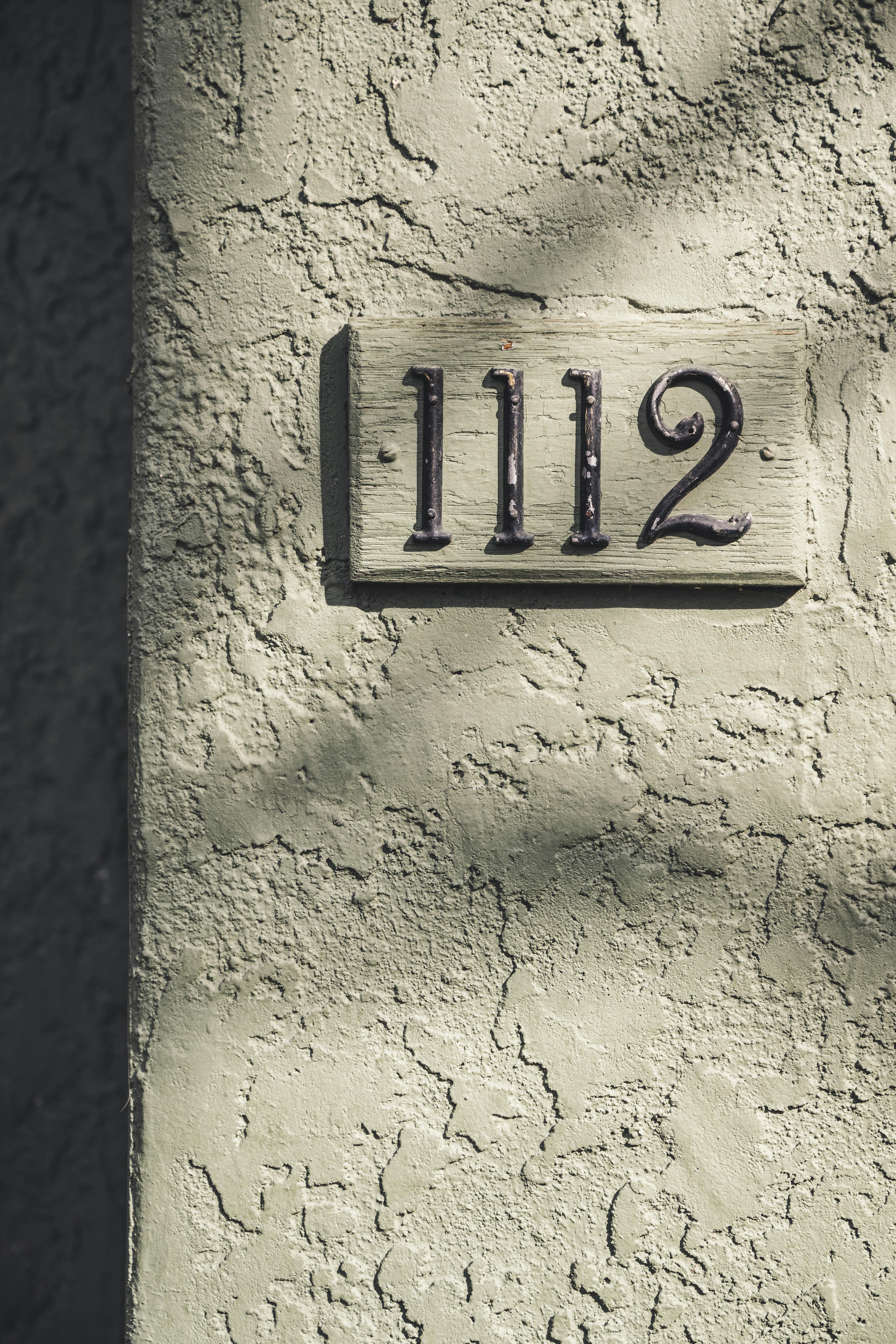 Closeup of a House Number Plate on the Wall · Free Stock Photo