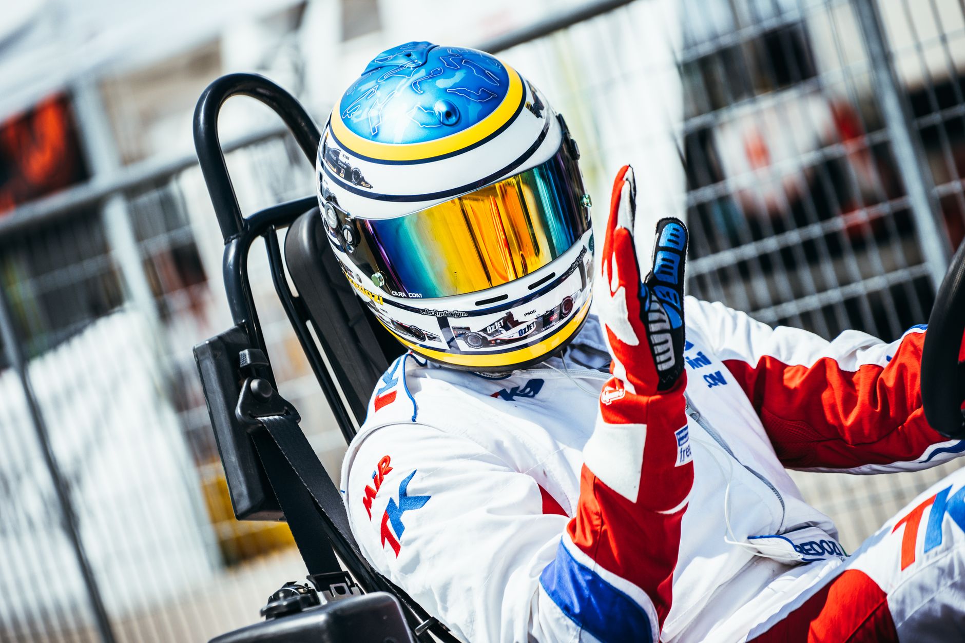 Dynamic shot of a go-kart racer at speed, showcasing vibrant gear and helmet design.