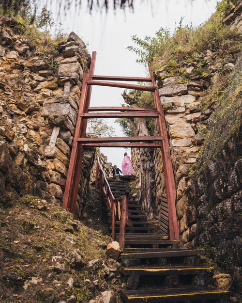 Free Explore ancient stone ruins through a wooden staircase in Chachapoyas, Peru. A glimpse into history. Stock Photo