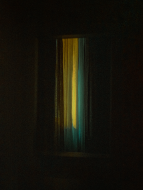 Free A dimly lit window with moody curtains casting a soft, serene glow in a dark room. Stock Photo