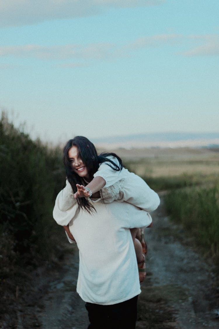 Couple Hugging On A Path On Field