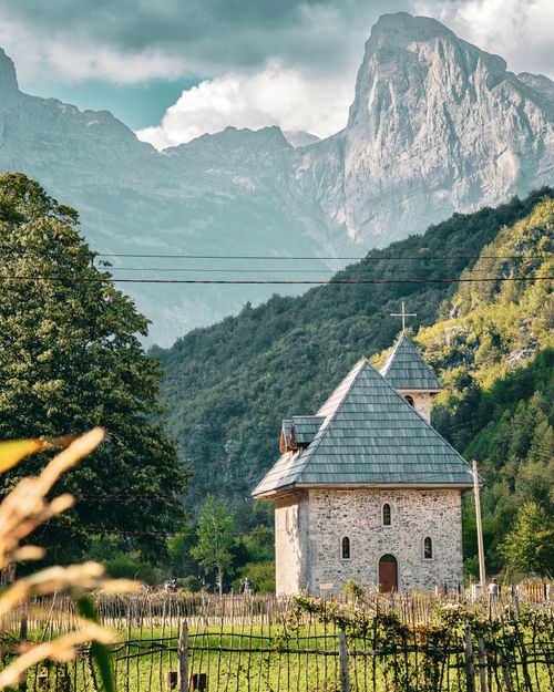 Free Discover a quaint chapel nestled in the picturesque Theth Valley, surrounded by majestic Albanian mountains. Stock Photo