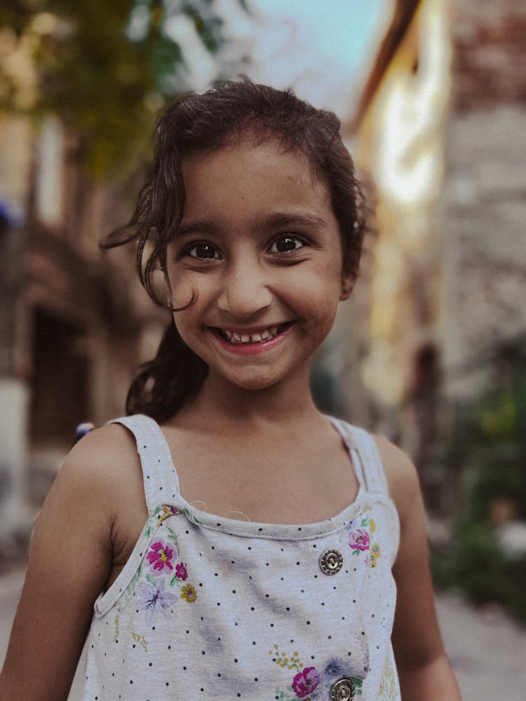 Portrait Of A Young Happy Girl Standing Outside 