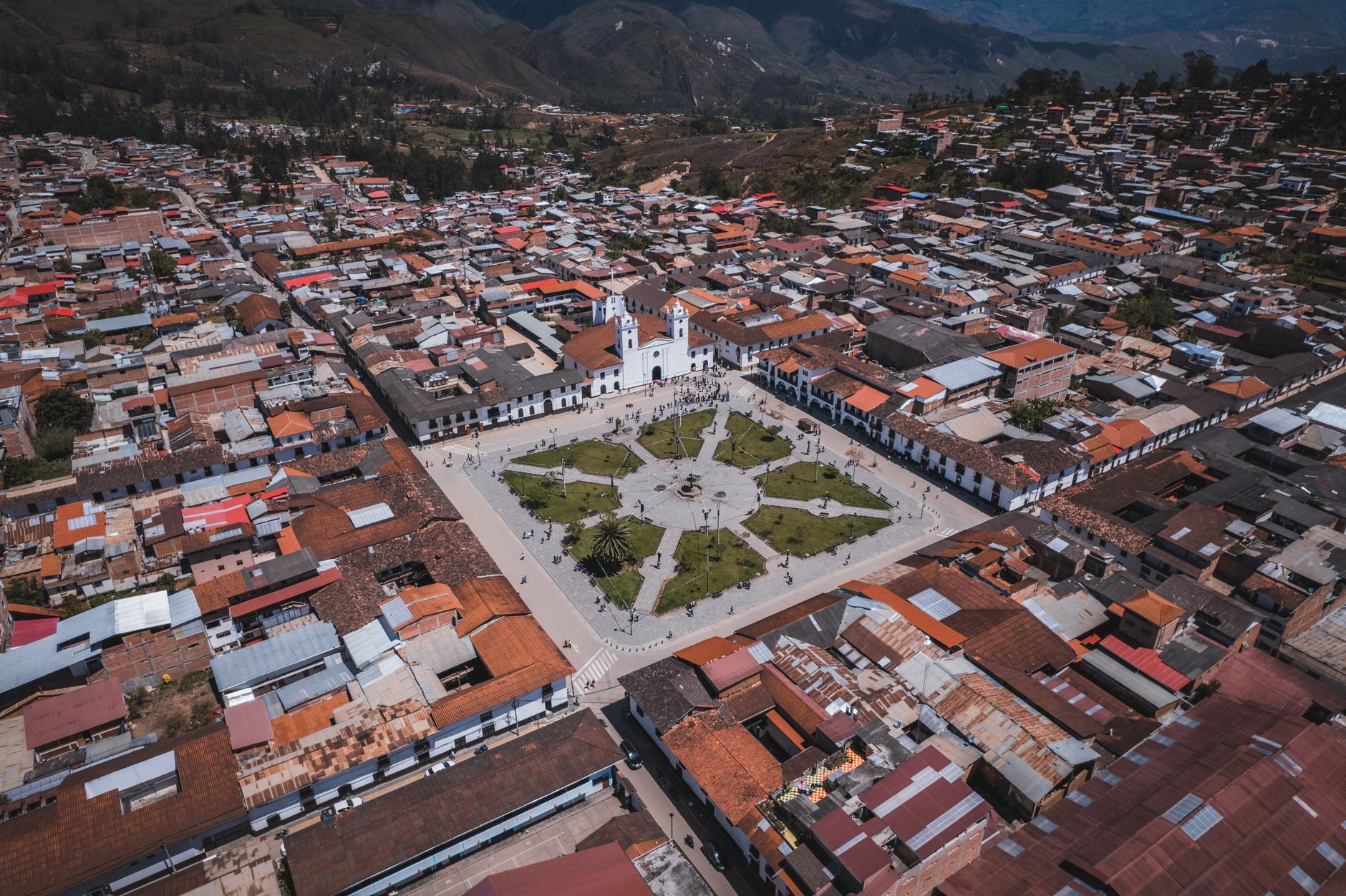 Stunning aerial view of Chachapoyas' Plaza de Armas with surrounding townscape, captured on a sunny day.