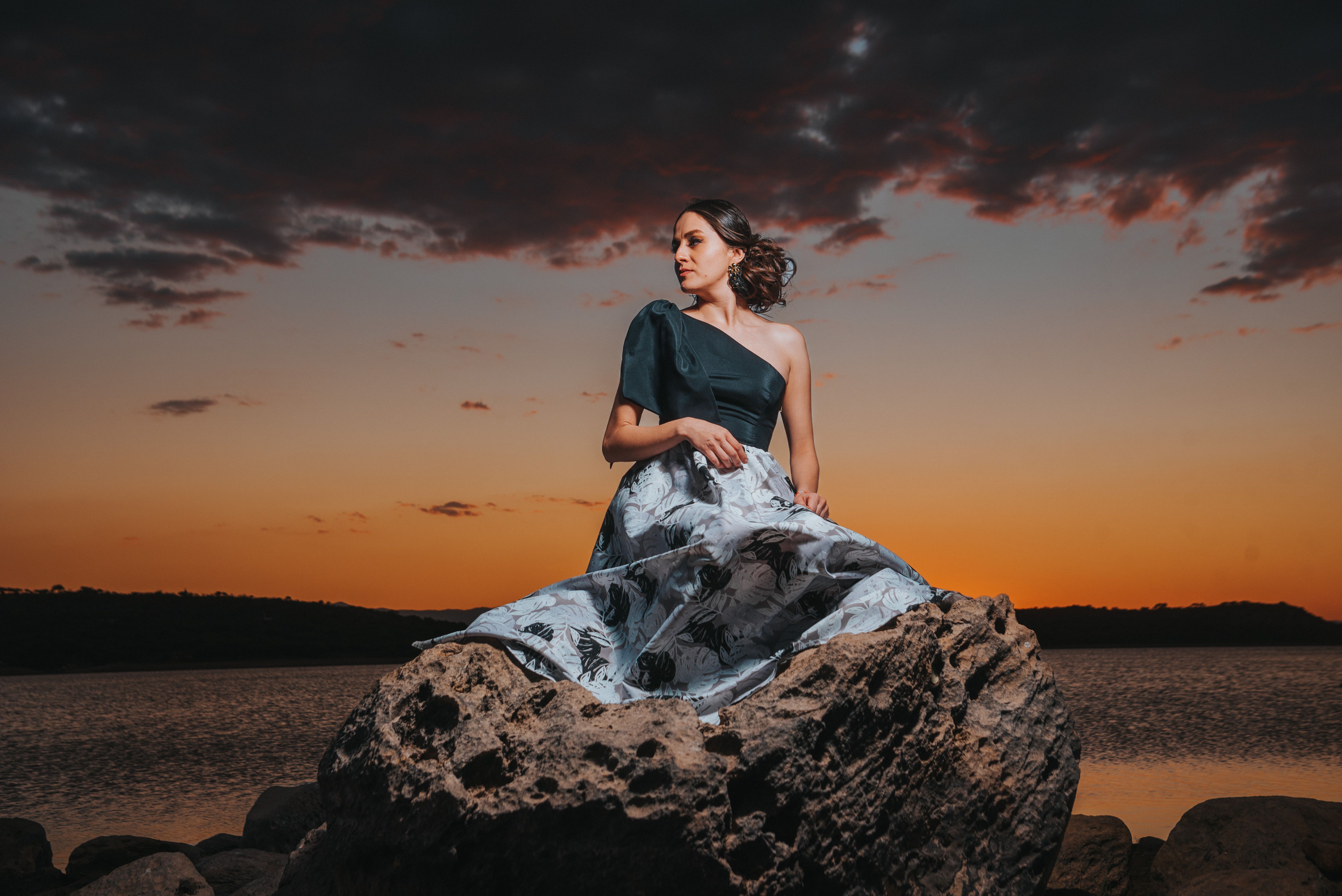 A Woman Sitting on a Rock · Free Stock Photo