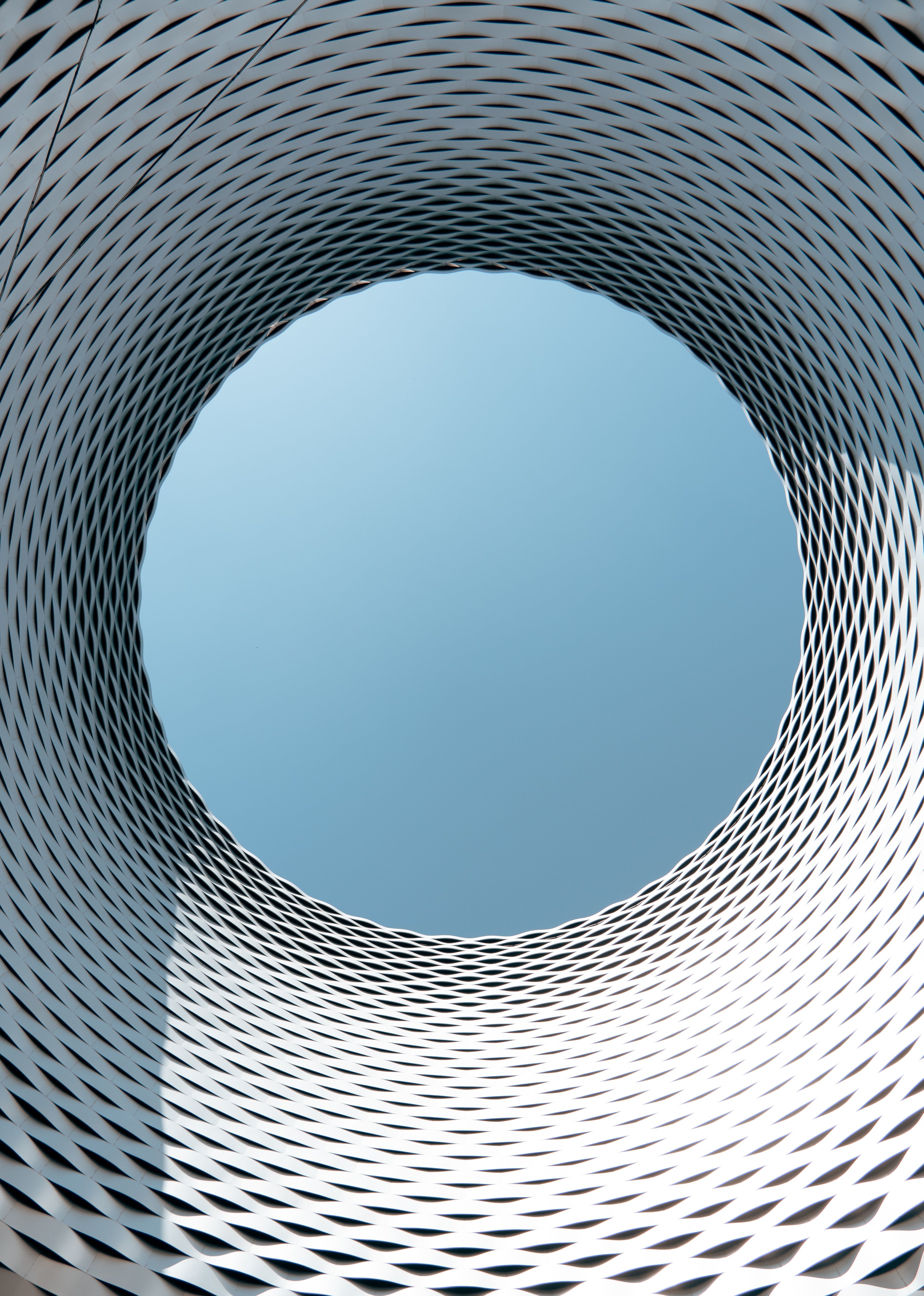 Futuristic architectural design with a geometric circular opening revealing the sky, located in Basel.