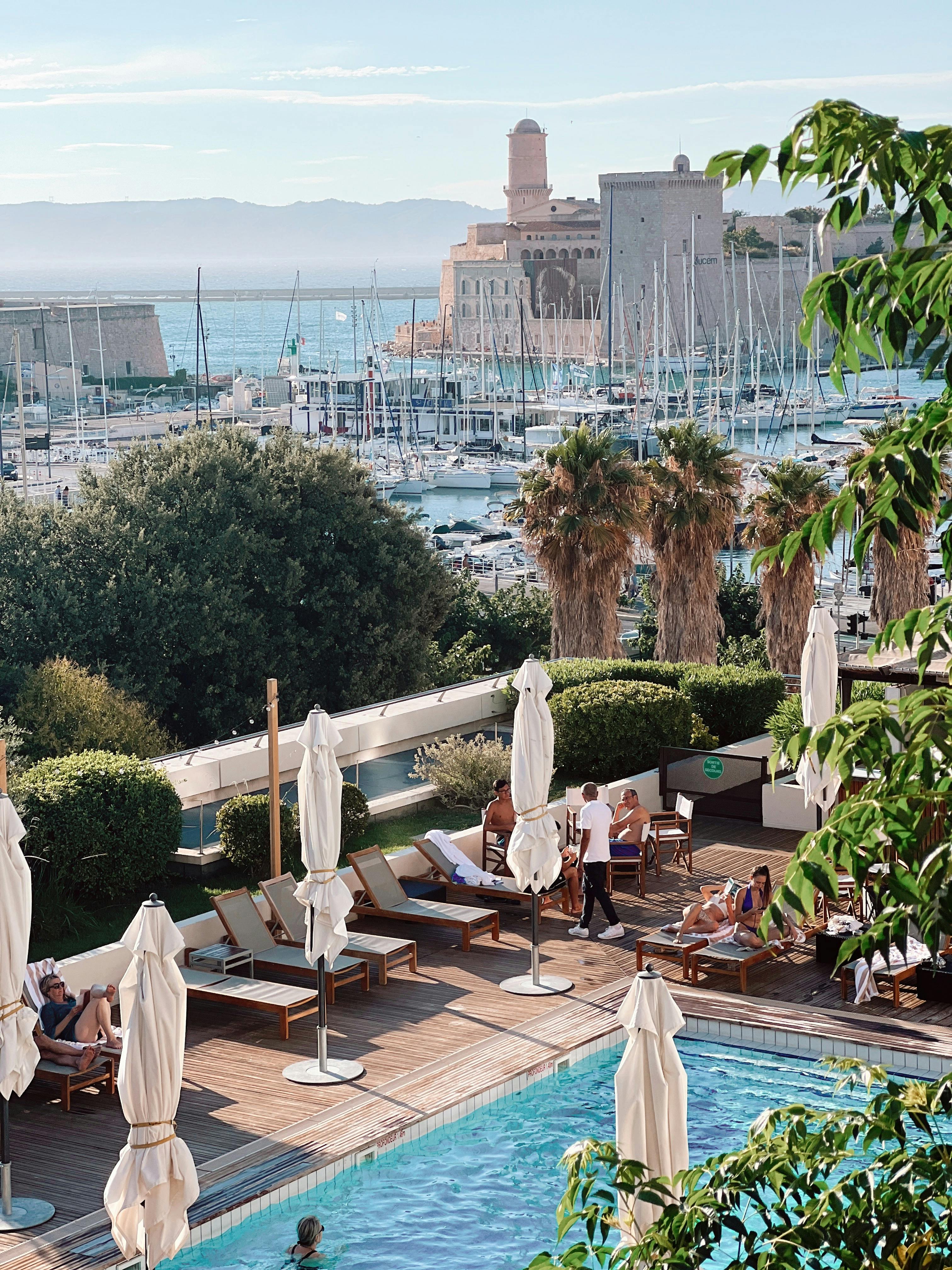 Deckchairs and pool by Mediterranean marina