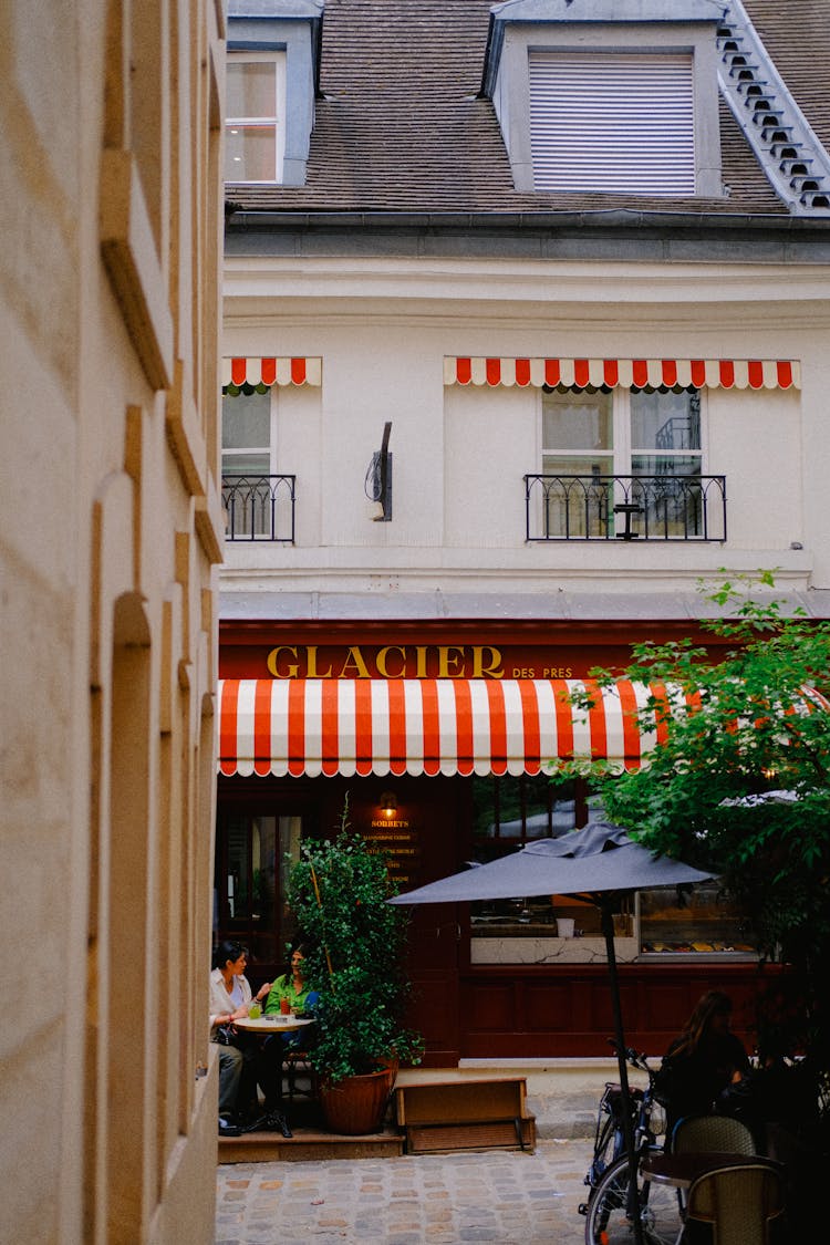 People Sitting In Cafe On A Paris Street