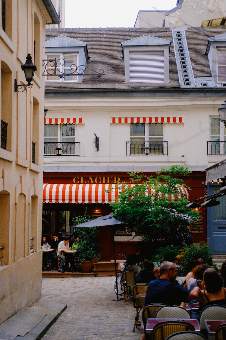 People Sitting In Street Cafes In An Old City Quarter