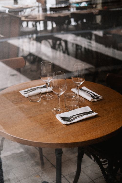 Free Elegant table set for dining with glasses and cutlery in a cozy restaurant. Stock Photo