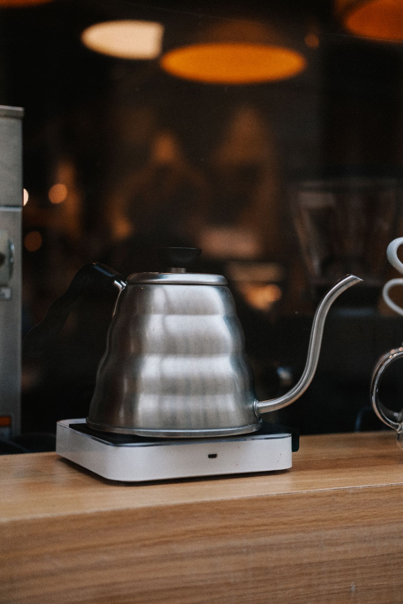 Pouring a slow, controlled stream over a coffee bed