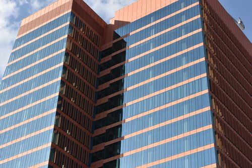 Free A striking modern skyscraper with reflective blue glass and a distinctive facade in Mexico City. Stock Photo