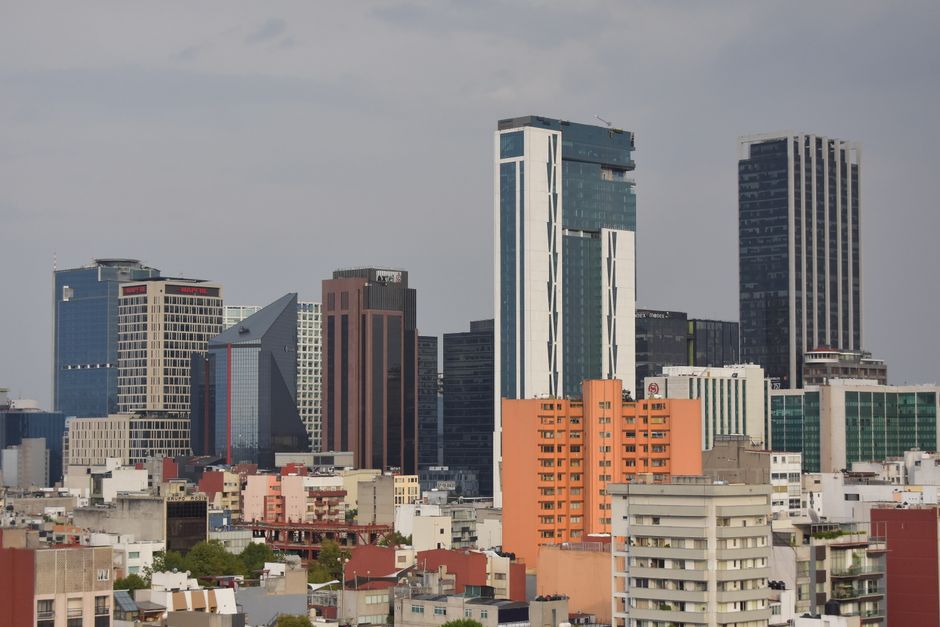 A modern skyline view of Mexico City featuring high-rise skyscrapers and urban architecture.