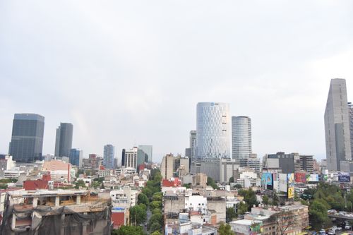 Free Aerial view of Mexico City's modern skyline with tall skyscrapers and urban landscape. Stock Photo