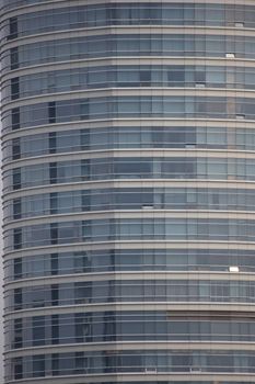 Close-up of a modern urban high-rise architecture with reflective glass windows.