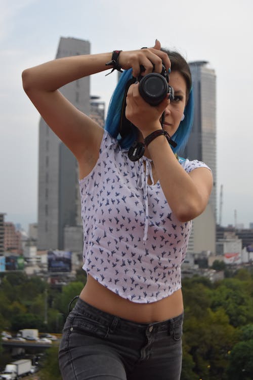 Woman Making a Photo Camera with Skyscrapers in Background