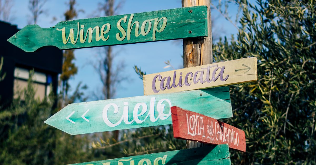 Colorful Direction Signs on a Wooden Pole · Free Stock Photo