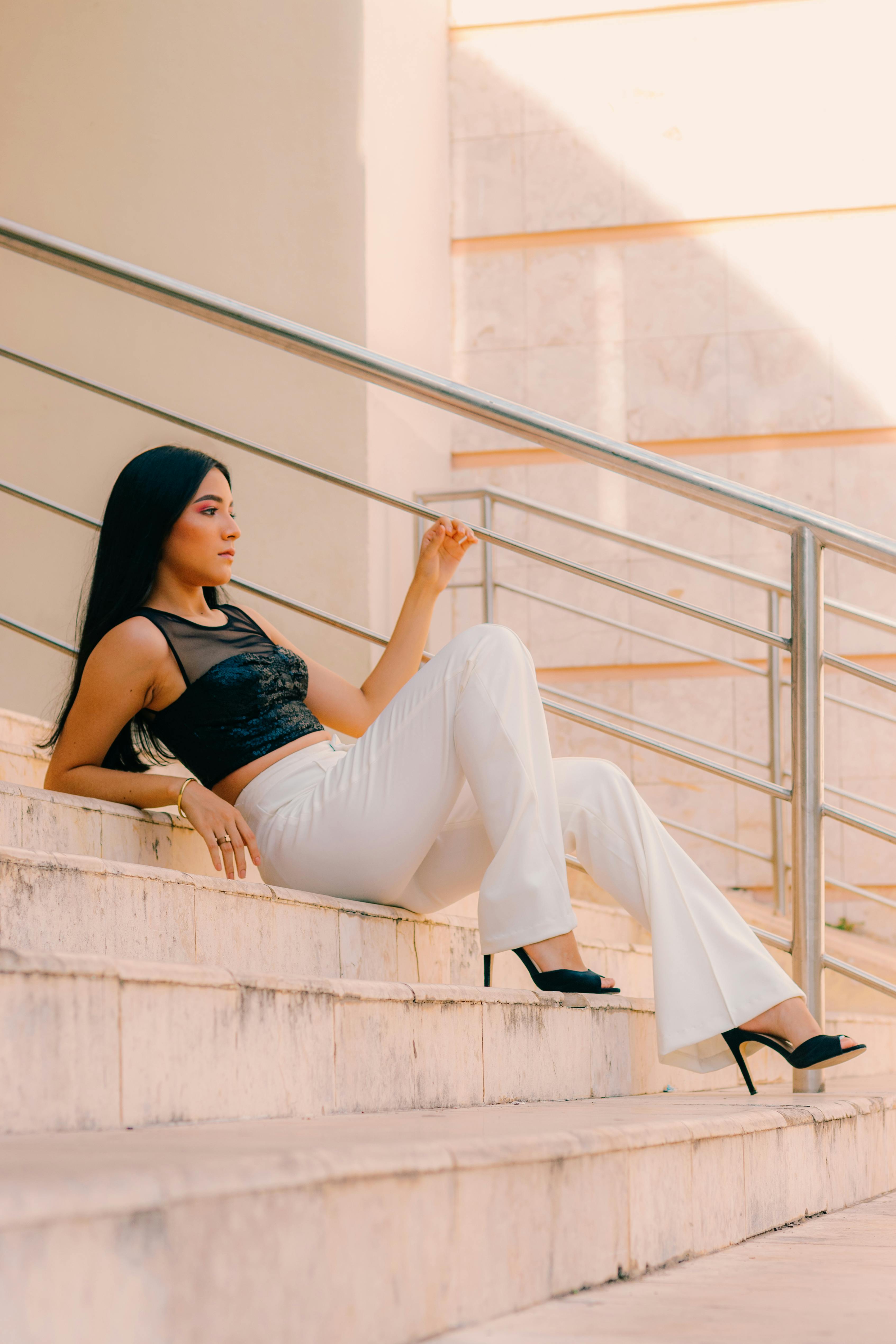 Young Brunette in a Leather Jacket and Camo Pants Sitting on a Train Track  · Free Stock Photo