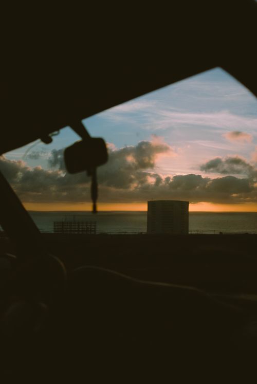 Free Peaceful sunset view from a car window in Rosarito, capturing the serene coastal scenery. Stock Photo