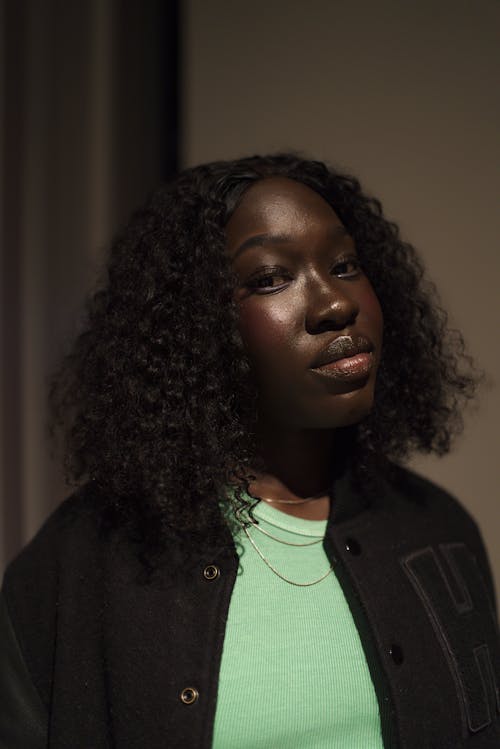 A woman with curly hair and a green shirt