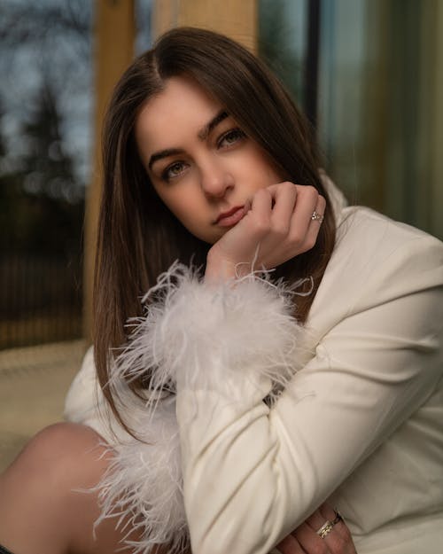 A young woman in a white jacket and white fur