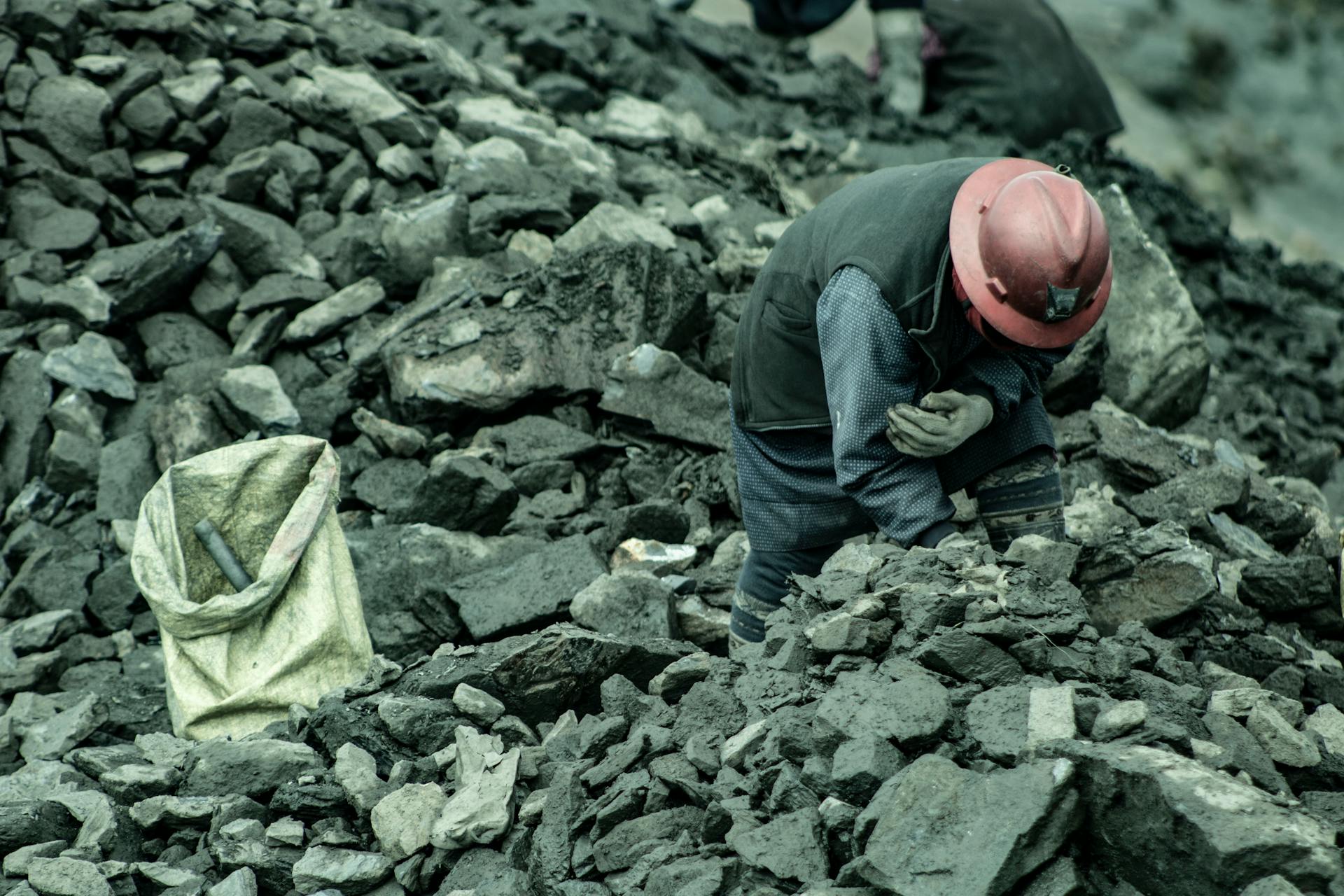 Woman Searching through the Stones Discarded from a Mine in Search of Gold